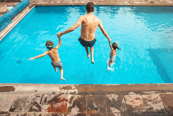 A family jumps into a pool