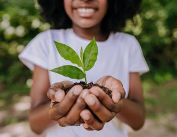 Girl holding plant