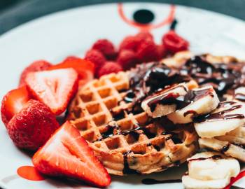 A plate of waffles and strawberries