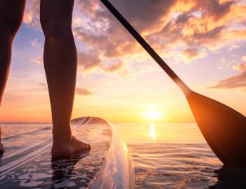 A man paddles on a stand up paddleboard