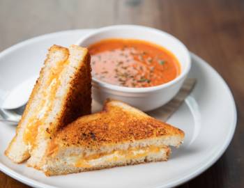A grilled cheese sandwich with tomato soup