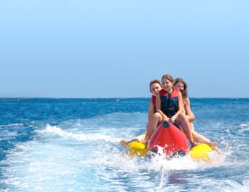 Children sit on a banana boat