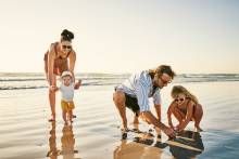 A family enjoy a day on the beach