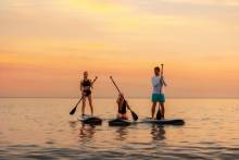 Friends paddleboarding on the waters of the Grand Strand