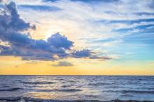 Atlantic ocean and sky with sunrise in background