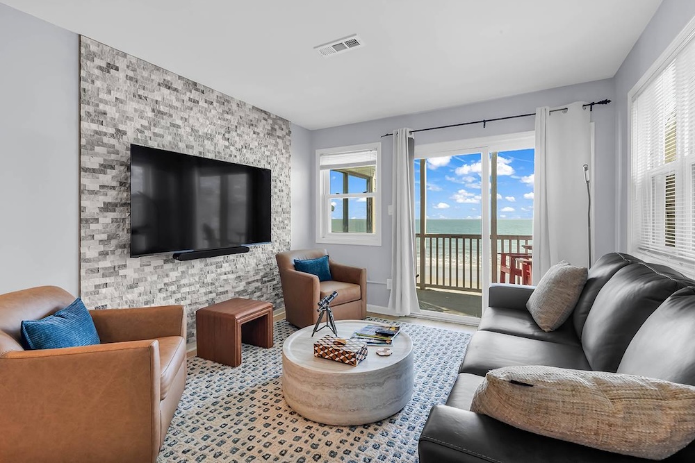 Vacation rental interior with balcony and ocean view in background