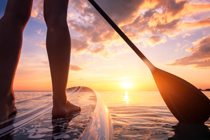 A person paddles on a stand up paddleboard