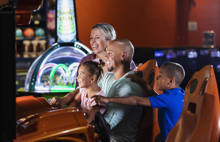 A family playing at an arcade in Myrtle Beach