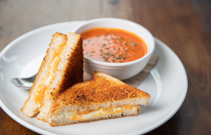 A grilled cheese sandwich with tomato soup