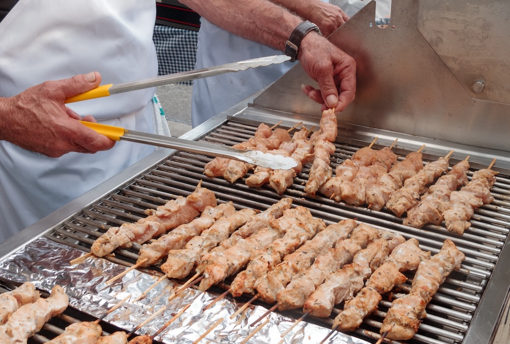 Closeup of a man grilling kebabs at a street festival